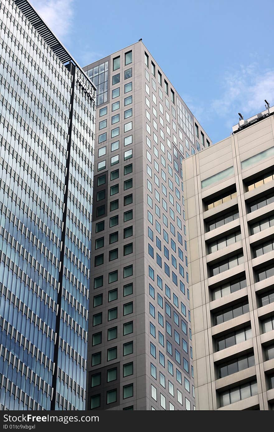 Three tall skyskrapers in downtown Tokyo, Japan against a blue sky. Three tall skyskrapers in downtown Tokyo, Japan against a blue sky