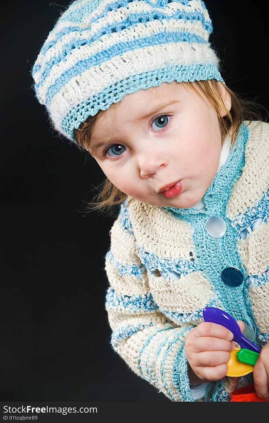 Little baby in a bound suit on black background, she learns to speak. Little baby in a bound suit on black background, she learns to speak