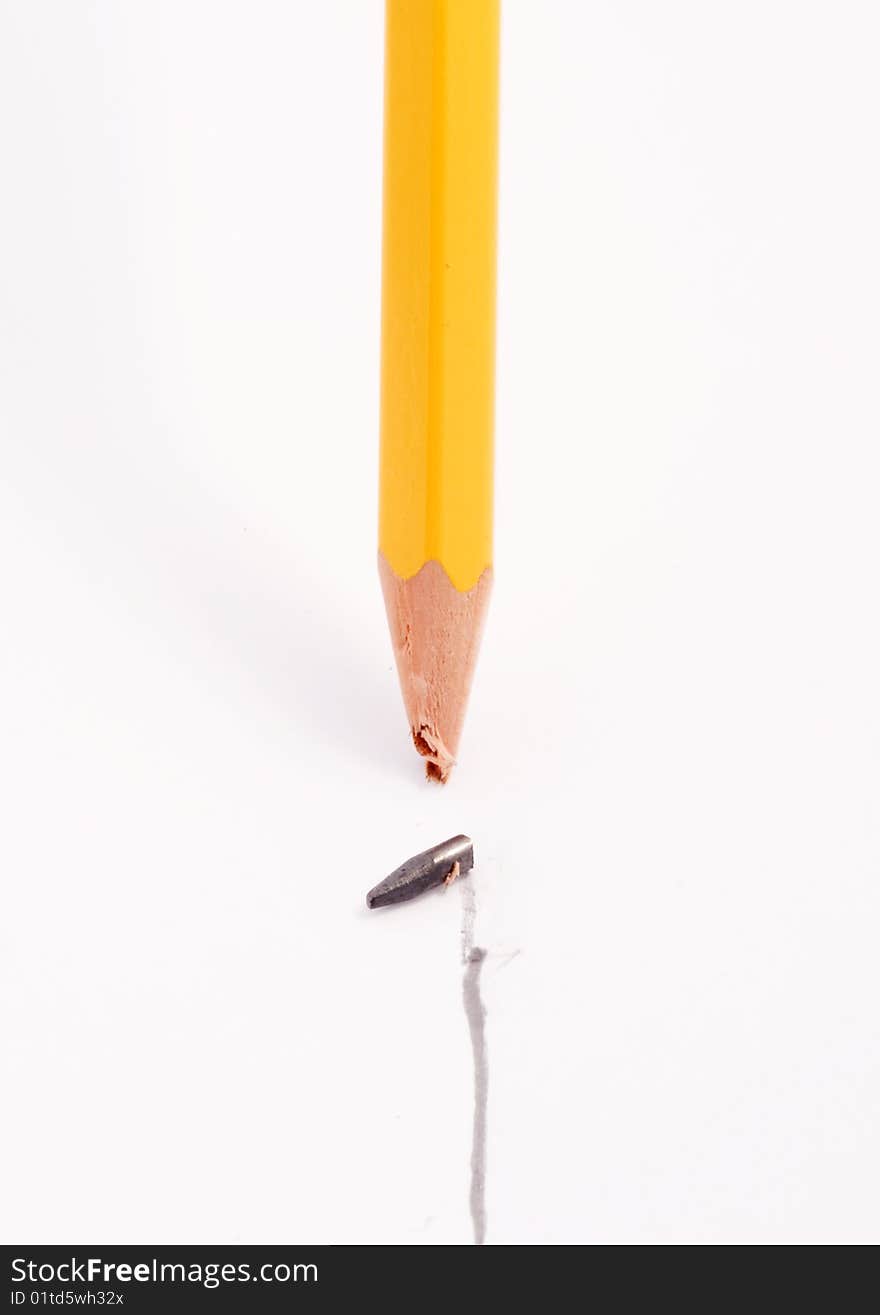 Yellow pencil with broken tip after drawing a straight line on a white background. Yellow pencil with broken tip after drawing a straight line on a white background.