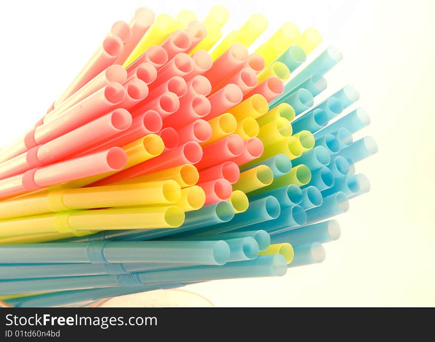 Bundle of colored drinking straws over a white background. Bundle of colored drinking straws over a white background.