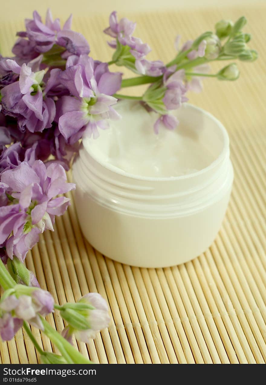 Spa essentials. Bowl of cream and flowers. Spa essentials. Bowl of cream and flowers.