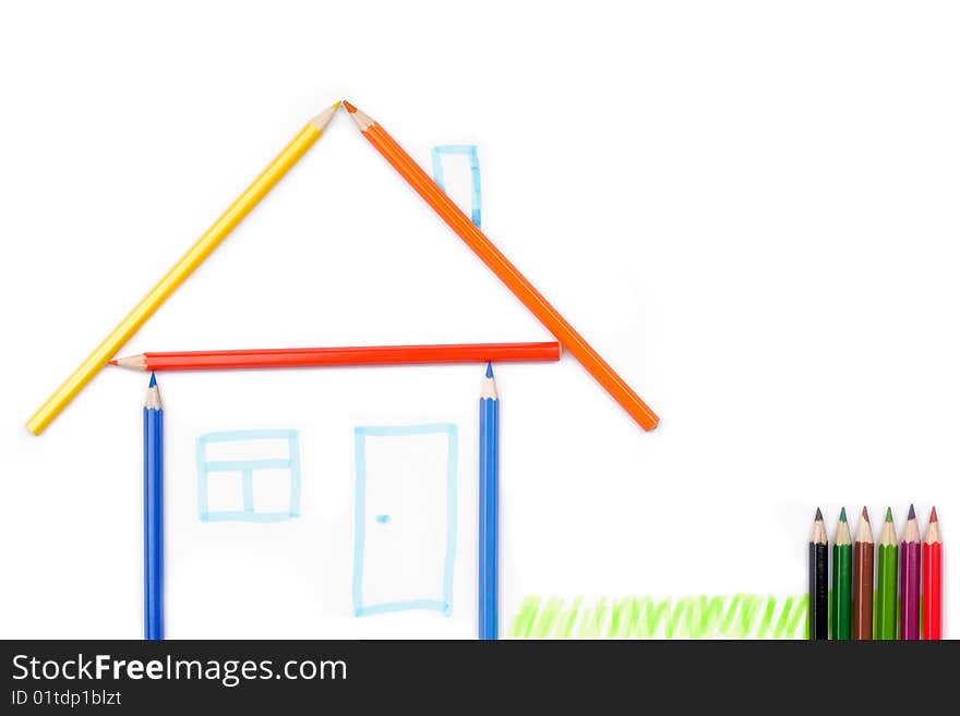 Color pencils formed in the shape of a house. Isolated on white background. Color pencils formed in the shape of a house. Isolated on white background.