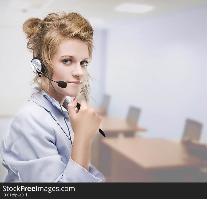 Woman wearing headset indoors in the office