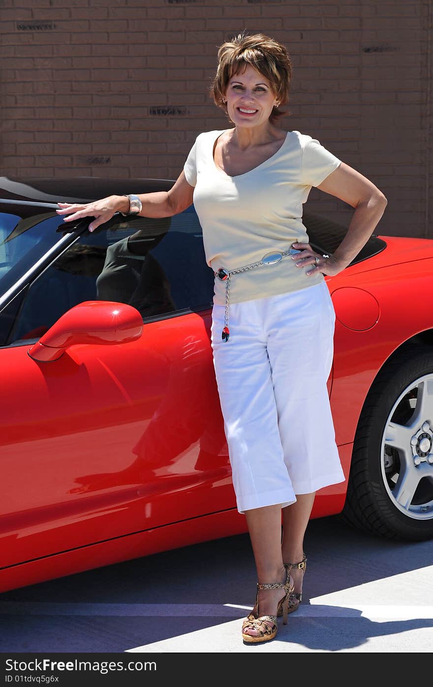 Attractive Woman with her Red Sports Car