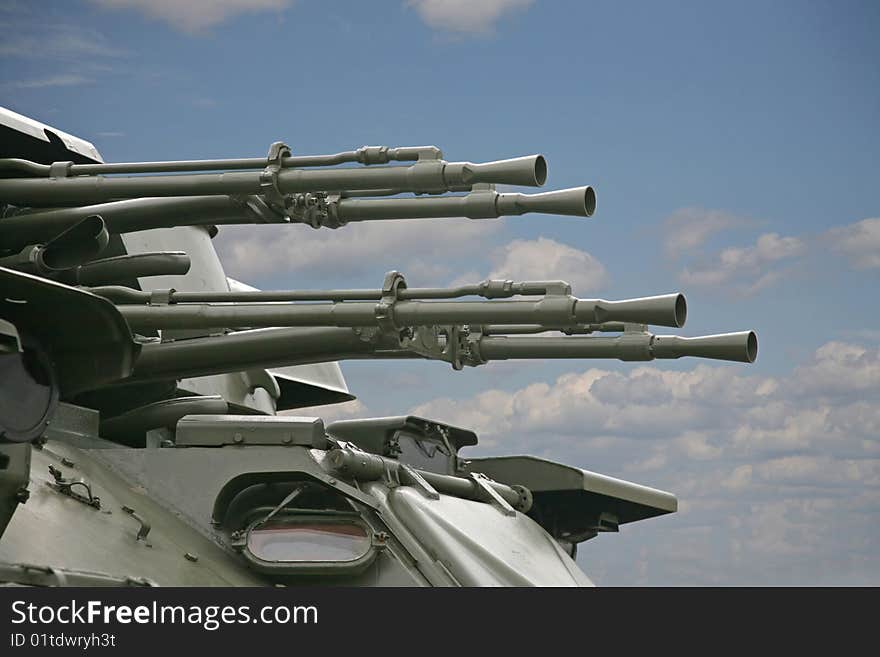 Trunks of an antiaircraft gun against the blue sky. Trunks of an antiaircraft gun against the blue sky