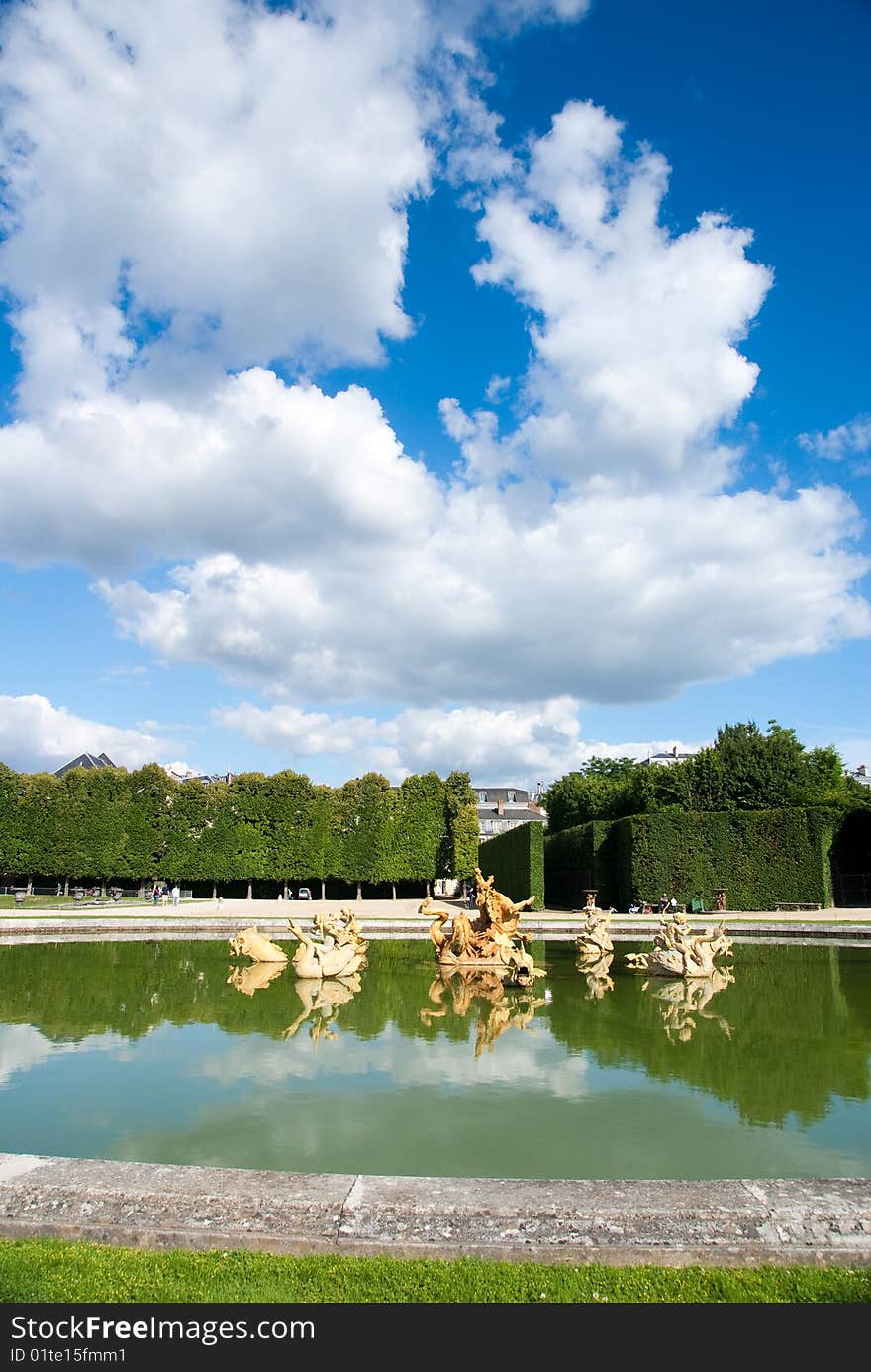 Classic fountain in paris royal park with water reflection