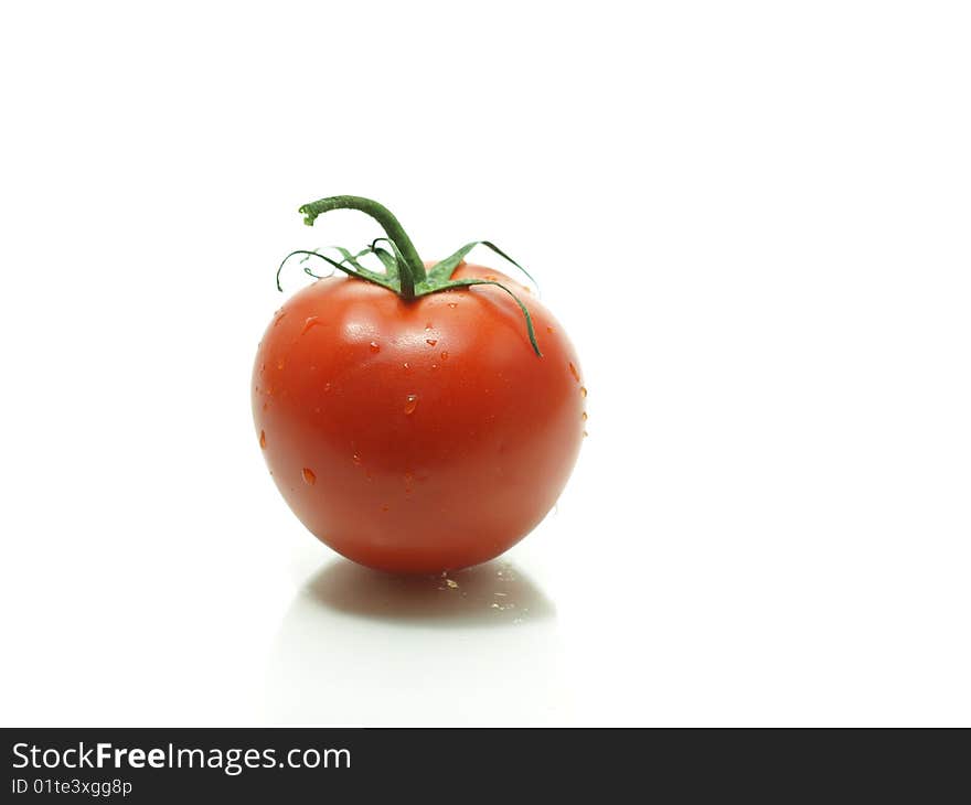 A juicy tomato fresh off the vine isolated on a white background.