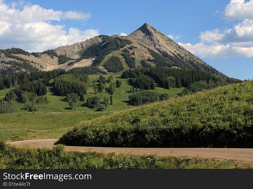 Lush green mountain scene on bright summer day. Lush green mountain scene on bright summer day.