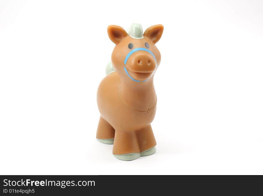 A toy brown horse looking at you on a white background. A toy brown horse looking at you on a white background.