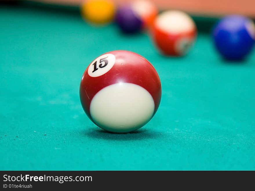 Pool billiard balls on a green table