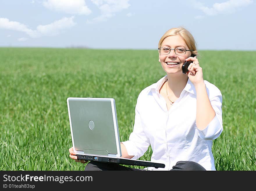 Business lady typing on laptop, sitting outdoors. Business lady typing on laptop, sitting outdoors.