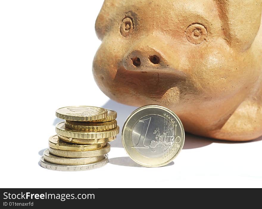 Stack of Euro coins in front of terracotta piggy bank. Stack of Euro coins in front of terracotta piggy bank