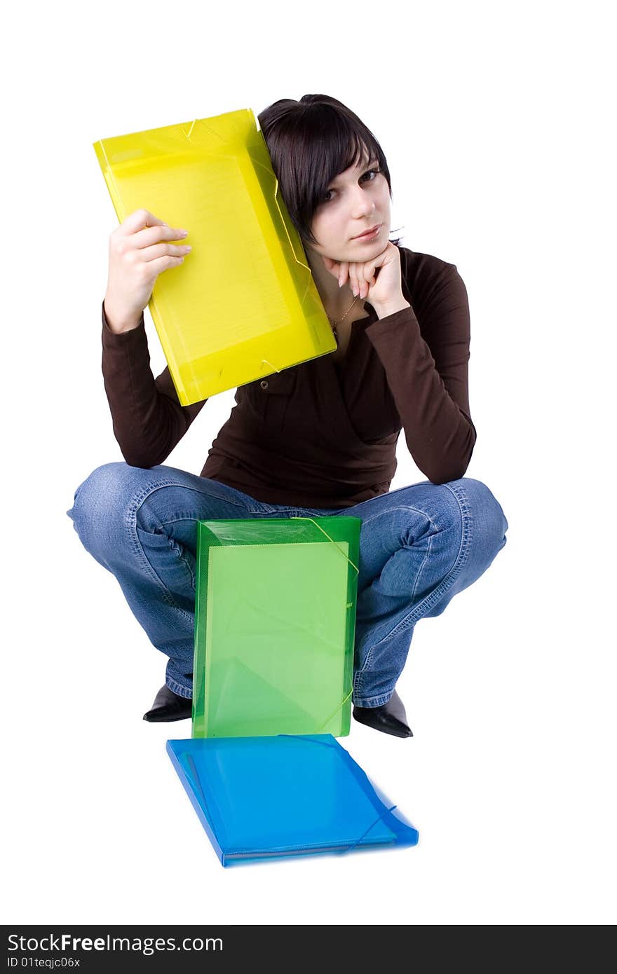 The young beautiful businesswoman at office behind work on a white background. The young beautiful businesswoman at office behind work on a white background