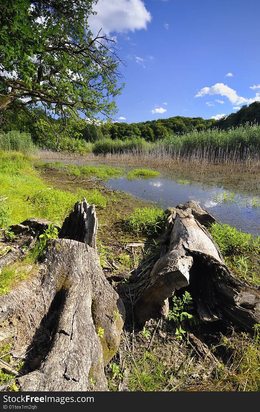 A small lake surrounded by wooded hills. A small lake surrounded by wooded hills