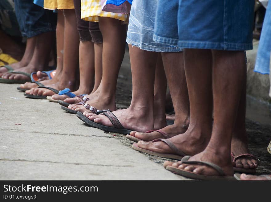 A line of feet of spectators in a rural area