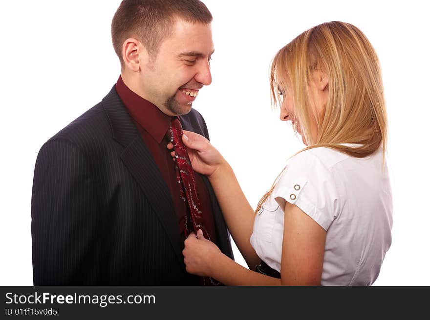 Beautiful blonde in a white blouse knotted necktie attractive man in a black suit. Beautiful blonde in a white blouse knotted necktie attractive man in a black suit