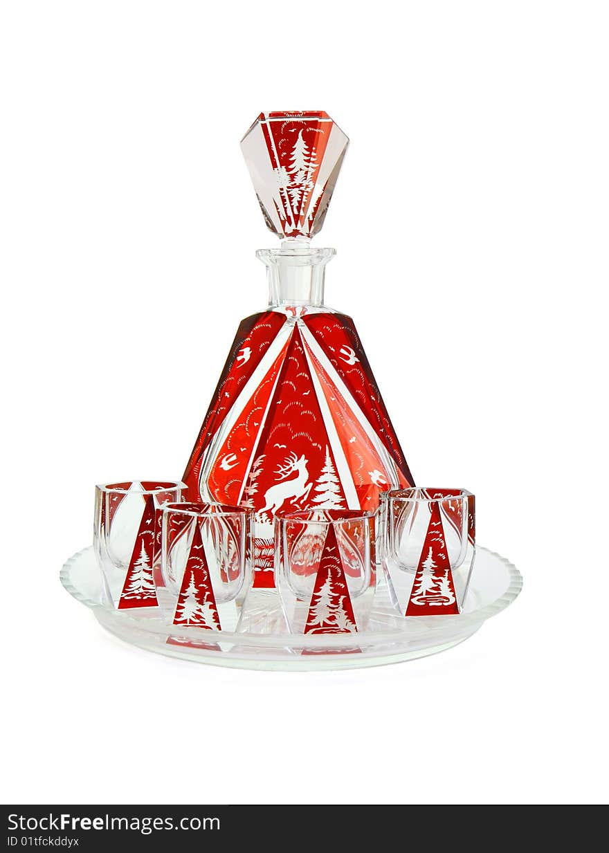 Red crystal carafe and liqueur-glasses on round plate isolated on white background