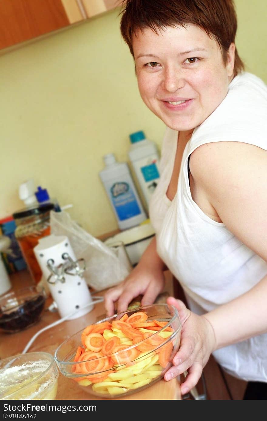 A beautiful woman is preparing food, smiling, happy. A beautiful woman is preparing food, smiling, happy