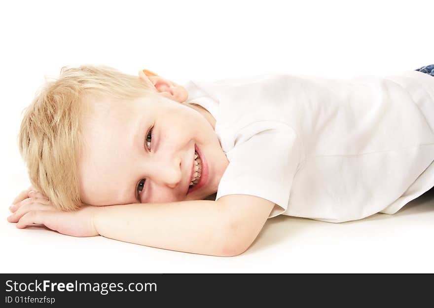 Laughing little boy laying on floor