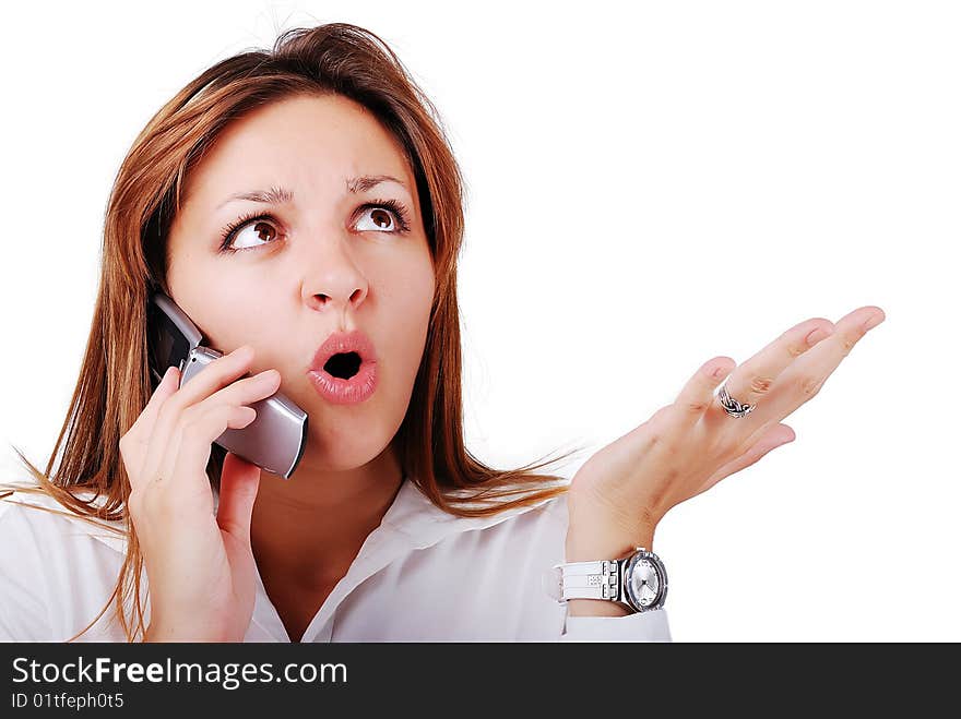 Young brunette with surprised expression on face speakin on cell phone