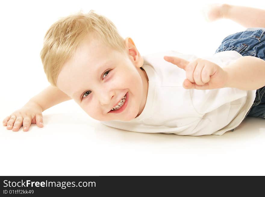 Laughing little boy laying on floor