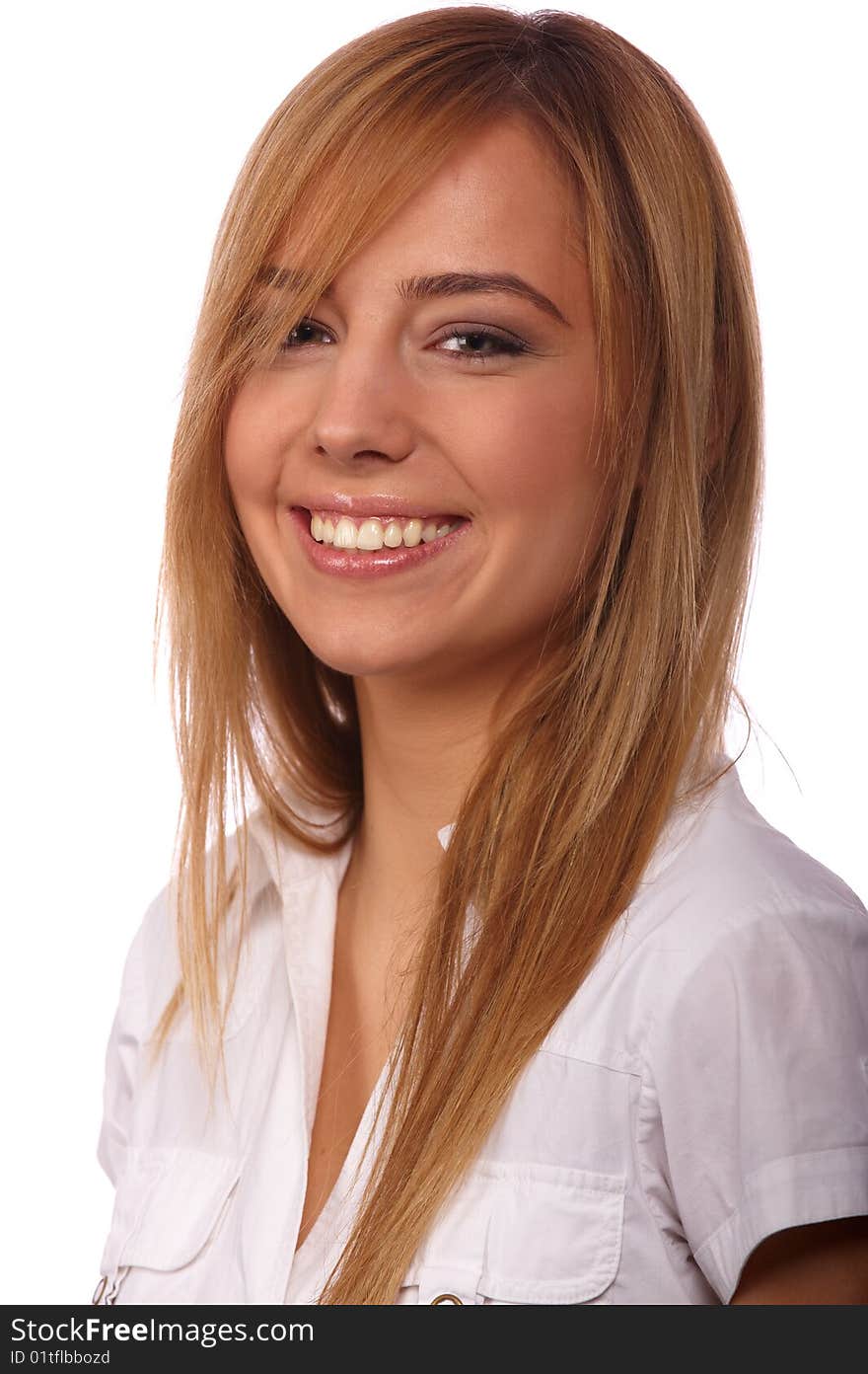 Portrait of a young beautiful smiling blonde in a white blouse on a light background. Portrait of a young beautiful smiling blonde in a white blouse on a light background