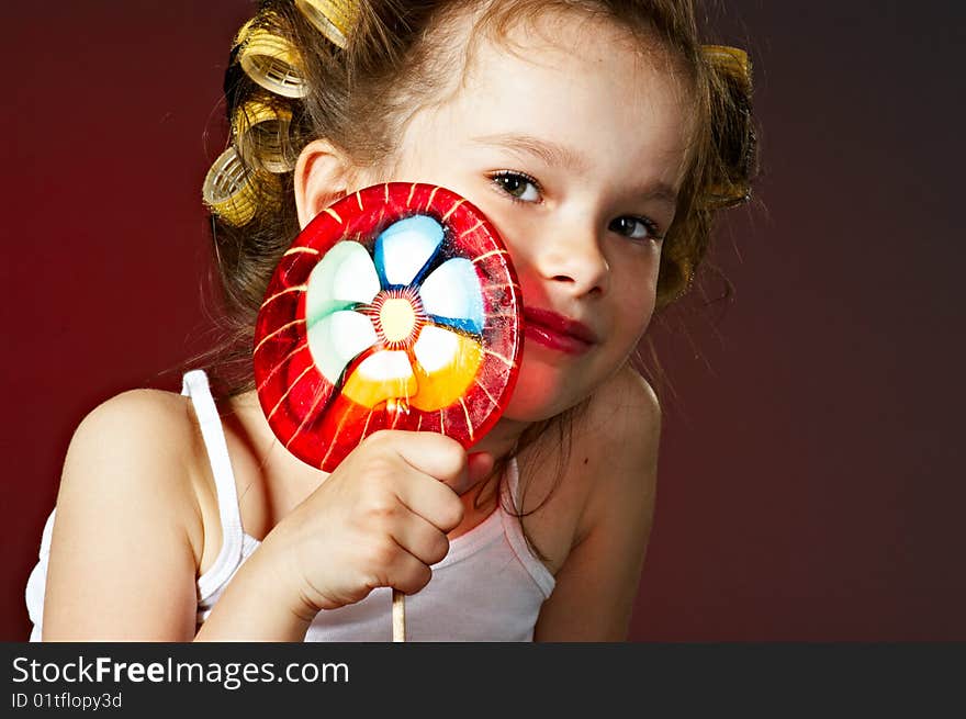 Closeup portrait of little girl with lollipop