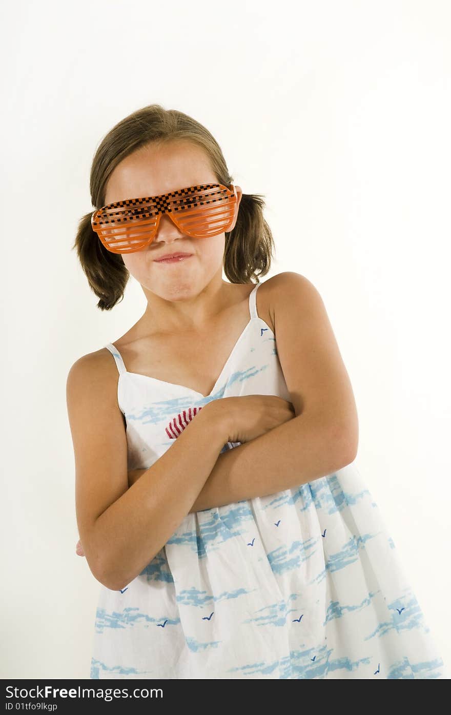 Young girl acting tough wearing goofy sunglasses, isolated on a white background. Young girl acting tough wearing goofy sunglasses, isolated on a white background.