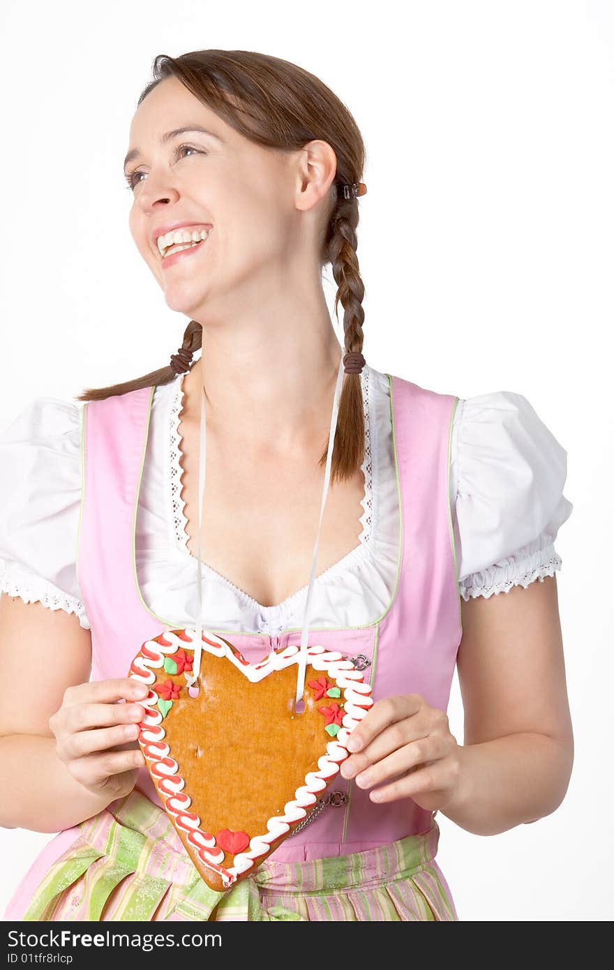 A young woman dressed in a traditional Bavarian Dirndl with a blank Herzl - on white. A young woman dressed in a traditional Bavarian Dirndl with a blank Herzl - on white