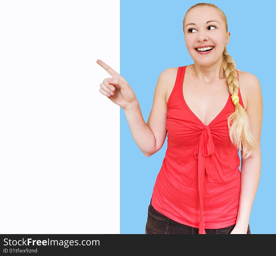 Happy smiling woman pointing towards white copyspace. Happy smiling woman pointing towards white copyspace