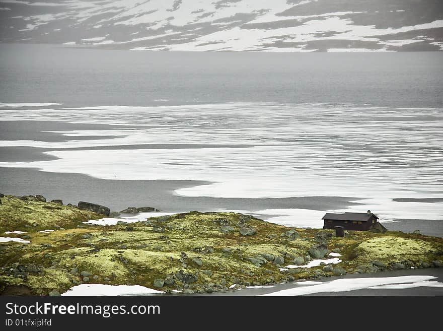 Small small house on the bank of high-mountainous lake. Summer. Norway. Small small house on the bank of high-mountainous lake. Summer. Norway