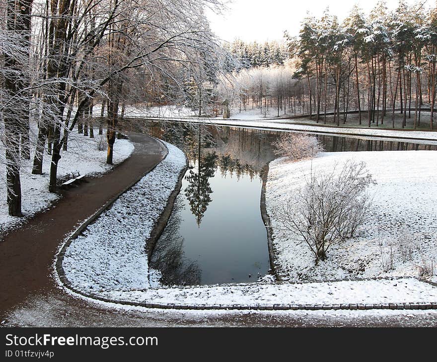 Winter park in the morning, pond in the middle parka