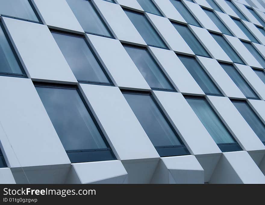 A photo of modern architecure - dark windows and white wall design. A photo of modern architecure - dark windows and white wall design