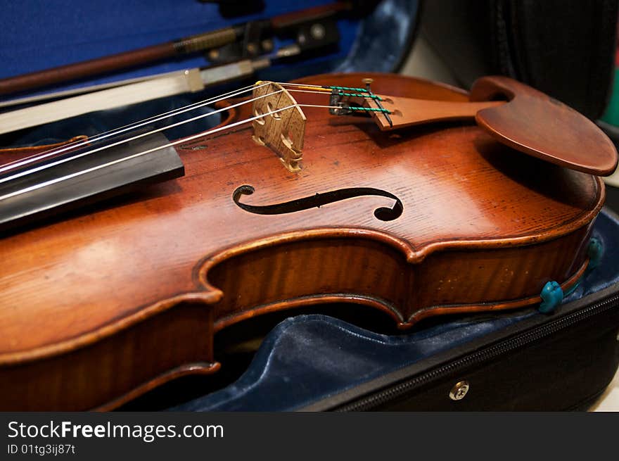 A violin in a case with its bow. A violin in a case with its bow