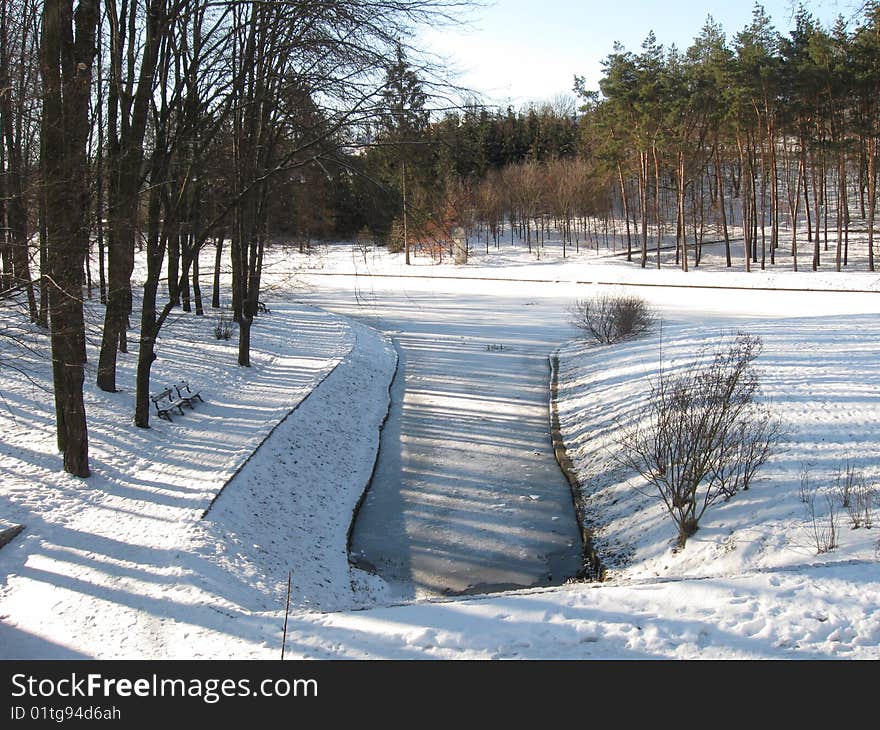 Winter park, the small river was covered ice. Winter park, the small river was covered ice