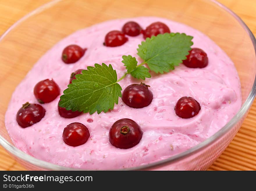 Red currants smoothie isolated on orange background.