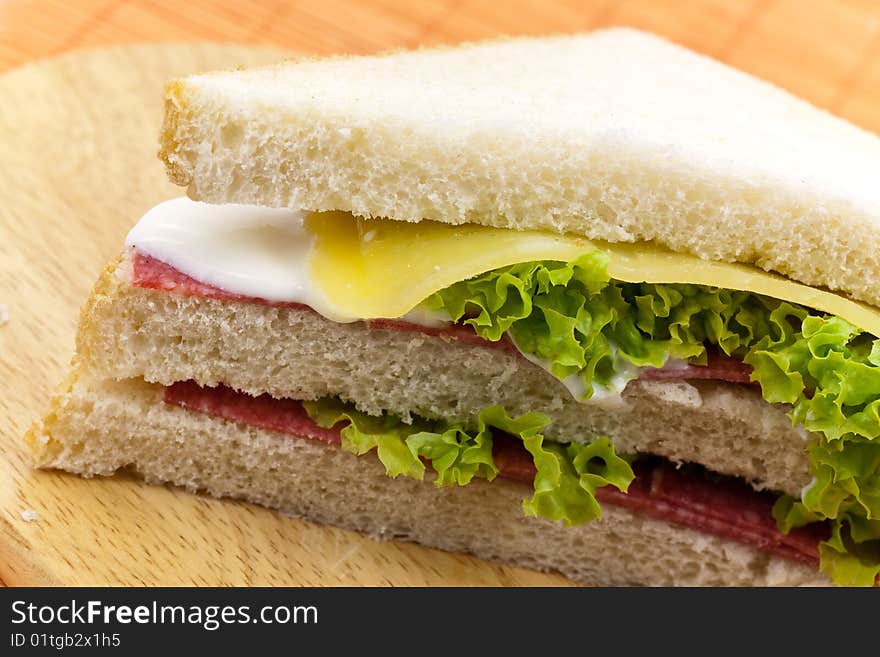 Layered sandwich isolated on orange