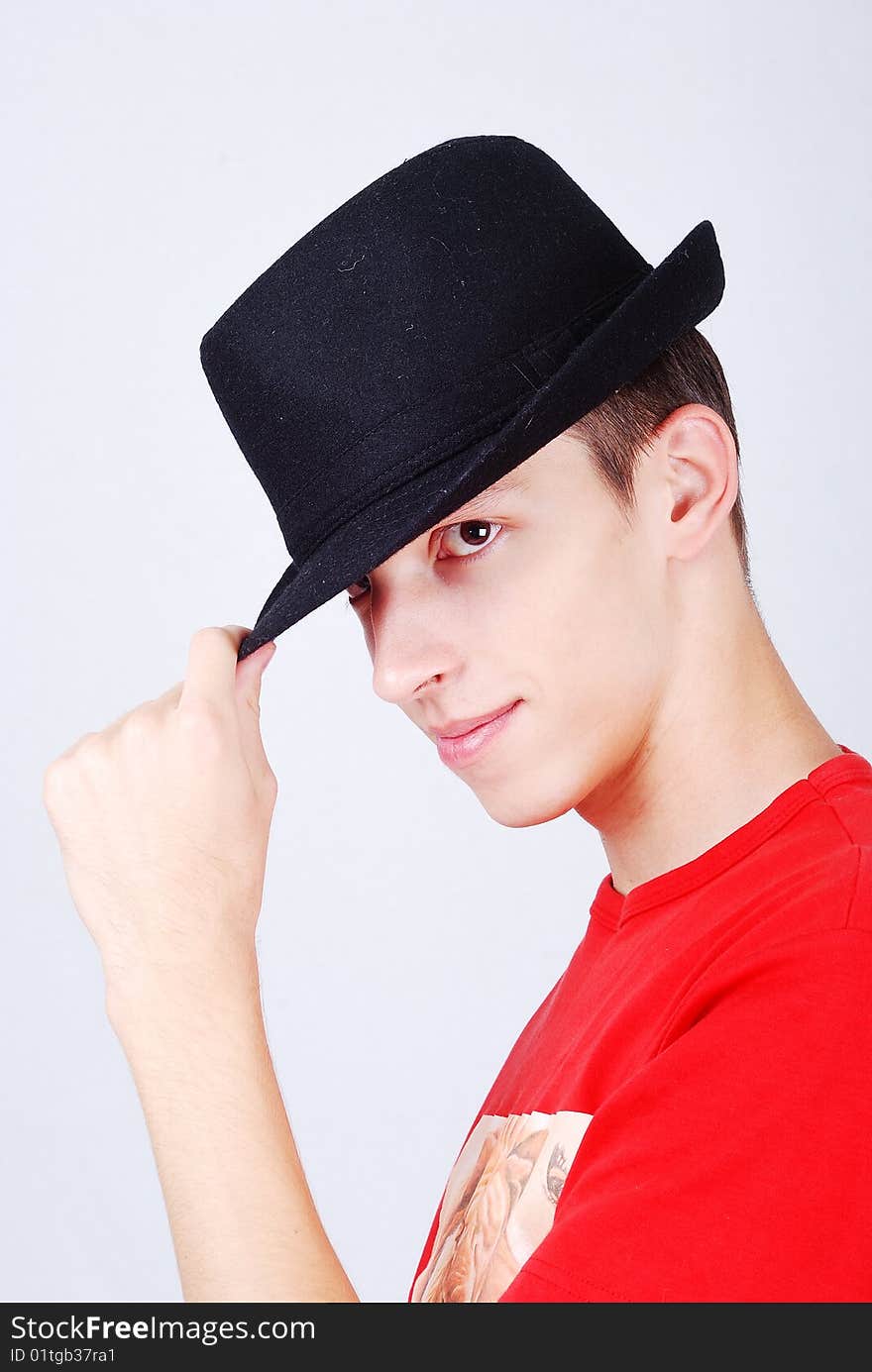 Young model with hat on head and salute expression