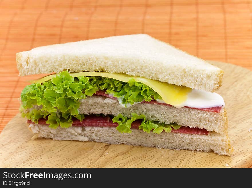 Layered sandwich isolated on orange