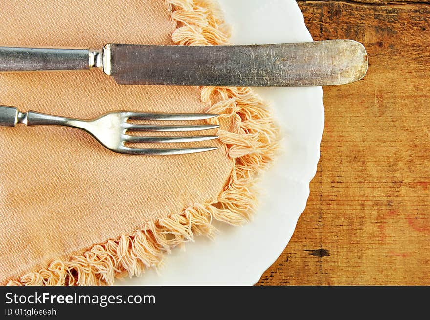 White Plate and Silverware Wooden Table