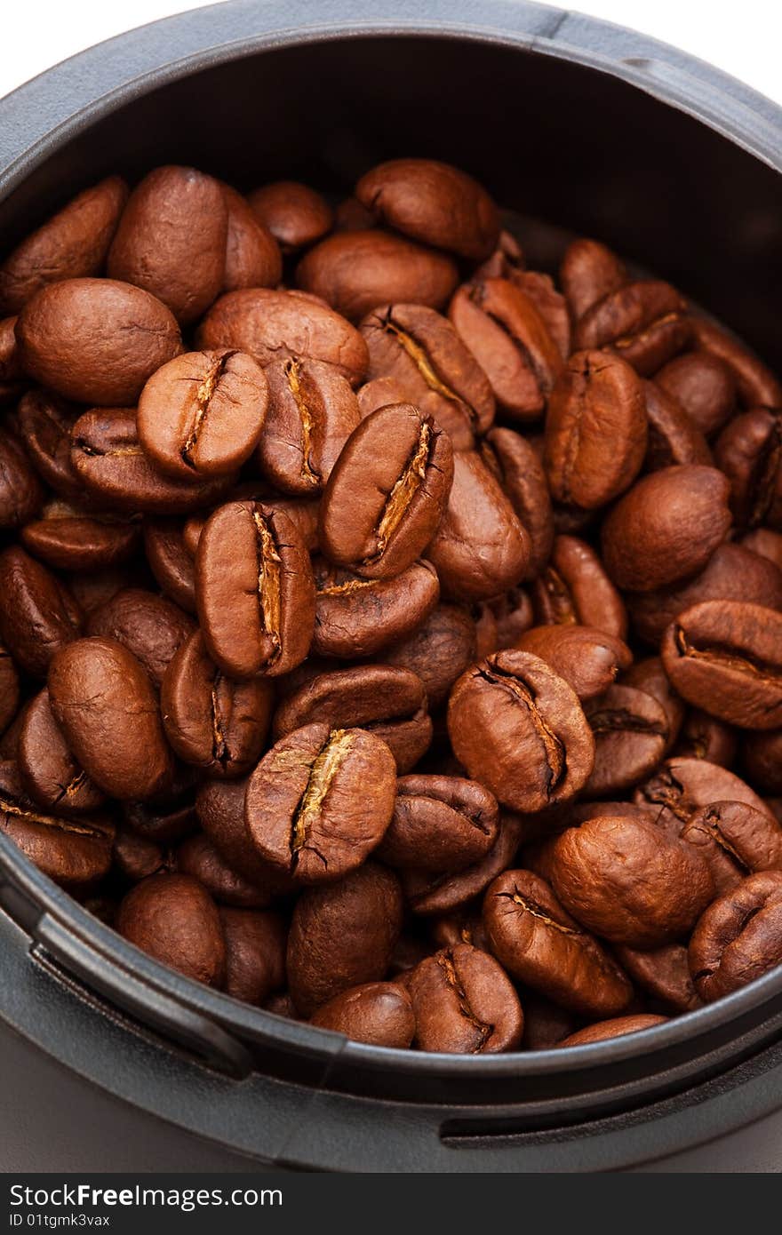 Roasted coffee beans grinders in close up