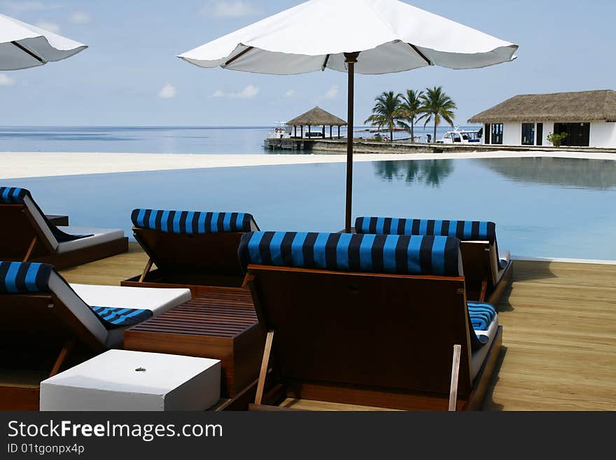 Sunshade and chairs at the pool. Sunshade and chairs at the pool