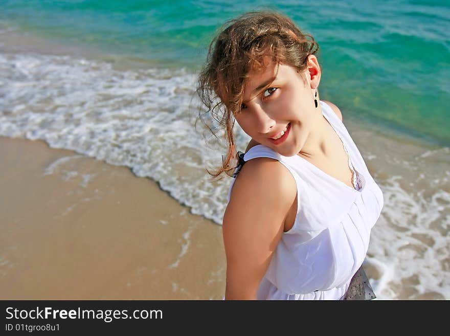 Beauiful girl in white dress on sea background