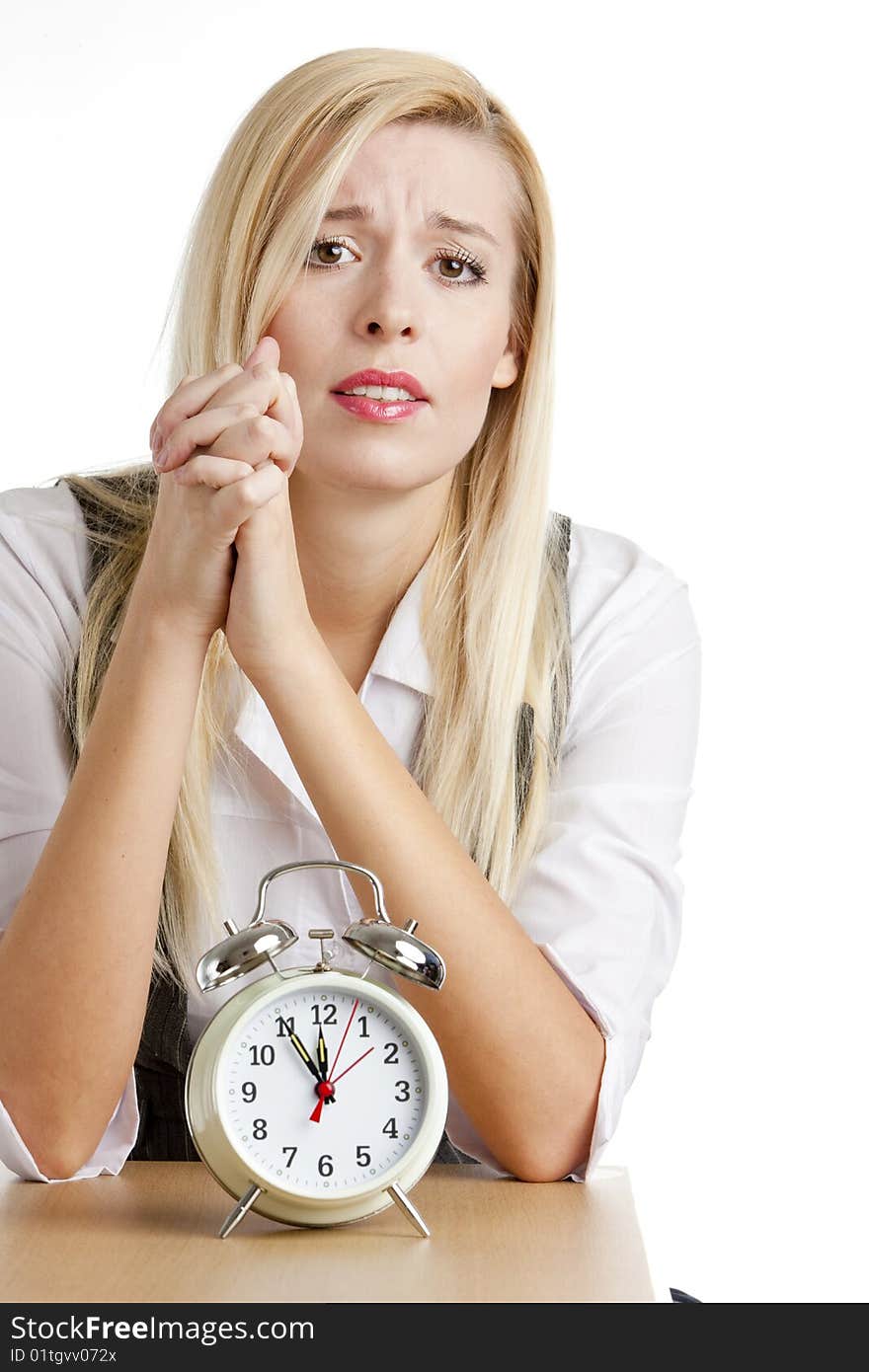 Portrait of businesswoman with an alarm clock