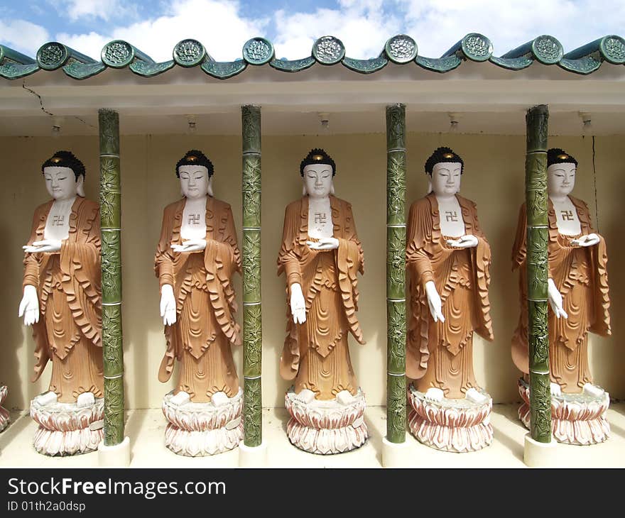 Five Buddha images with swastika at the Kek Lok Si temple in the hills above Georgetown, Penang, Malaysia. Five Buddha images with swastika at the Kek Lok Si temple in the hills above Georgetown, Penang, Malaysia