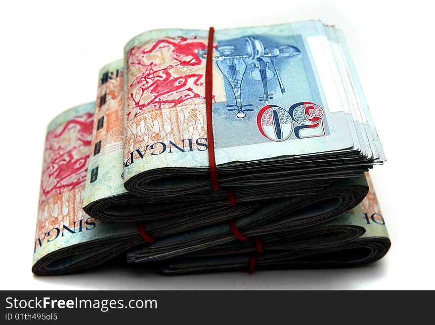 A lot of Singapore Dollars on white background.