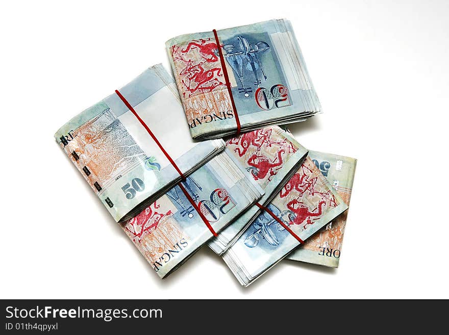 A lot of Singapore Dollars on white background.