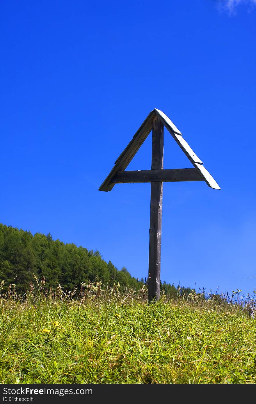 Wooden crucifix in the meadow