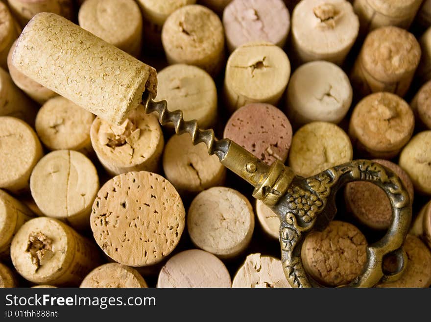 A closeup, detailed view on a stoppers from wine bottles, and old corkscrew. A closeup, detailed view on a stoppers from wine bottles, and old corkscrew