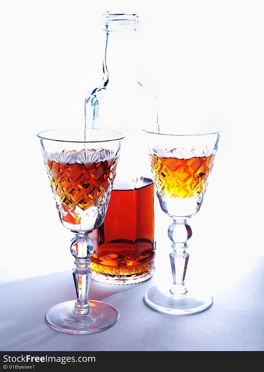 Color photo of a bottle and a glass of whiskey. Color photo of a bottle and a glass of whiskey